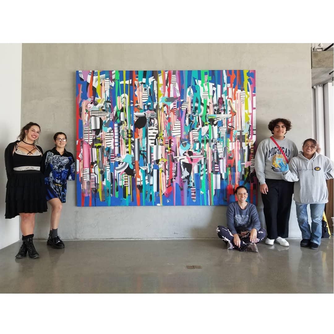 students in front of a painting