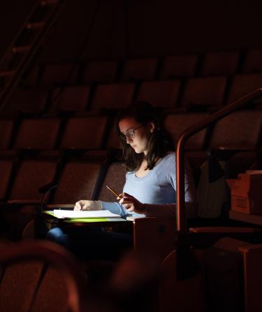 Woman Studying in a Theater