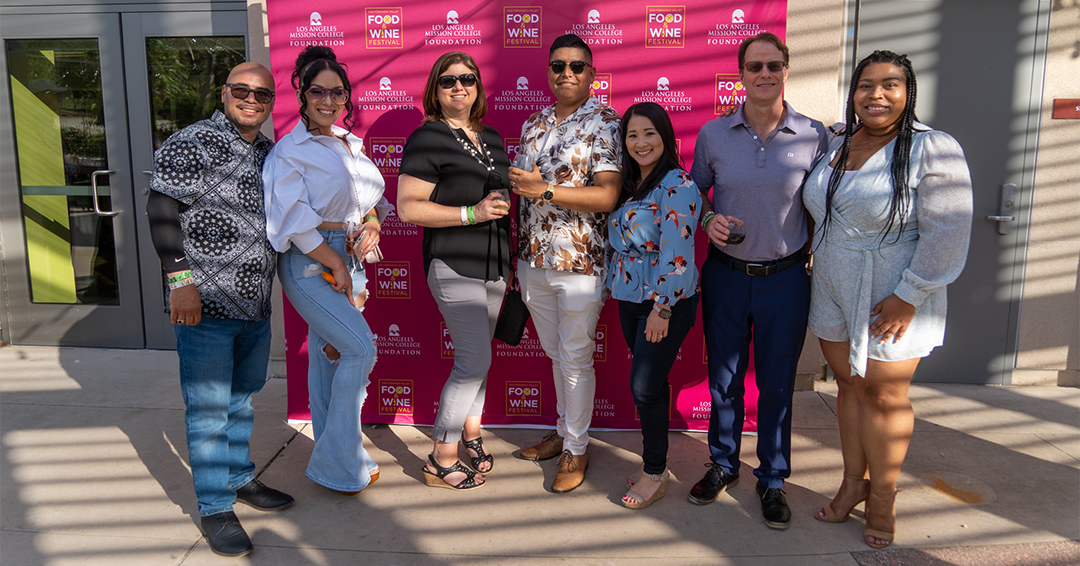 A group of attendees posing for a photo at the San Fernando Valley Food & Wine Festival